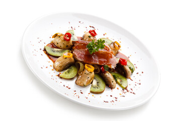 Carpaccio steak with vegetables and kiwi on white background
