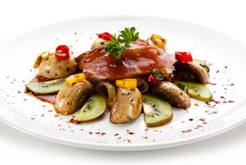 Carpaccio steak with vegetables and kiwi on white background