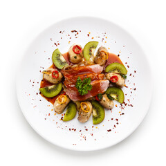 Carpaccio steak with vegetables and kiwi on white background