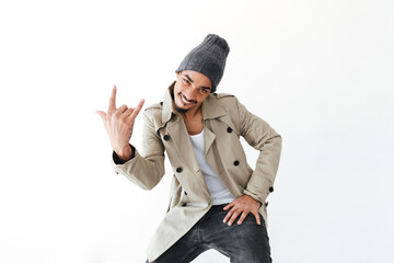 Smiling young african man showing rock gesture.