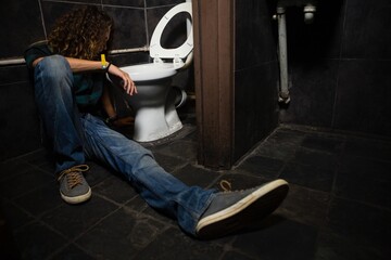 Man vomiting on toilet bowl