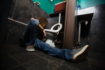 Man vomiting on toilet bowl
