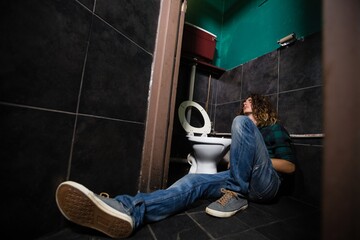 Fototapeta na wymiar Man sleeping in the washroom