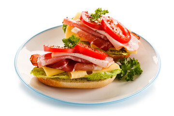 Sandwiches with meat, cheese and vegetables on white background