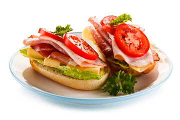 Sandwiches with meat, cheese and vegetables on white background