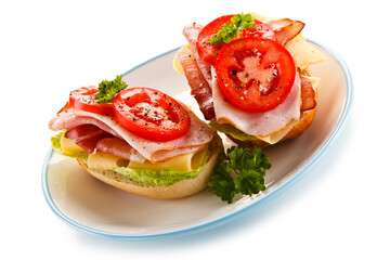 Sandwiches with meat, cheese and vegetables on white background