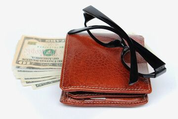 Wallets and glasses on a white background