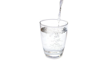 Water pouring in a glass isolated