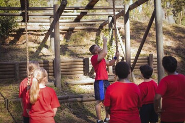 Trainer instructing kids in the boot camp