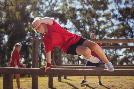 Kid Jumping Over The Hurdles During Obstacle Course Training