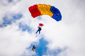 Man paragliding with Romanian flag colors