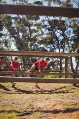 Kids jumping over the hurdles during obstacle course training