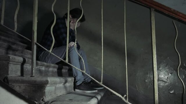 Drug abuse concept., overdose asian male drug addict hand, drugs narcotic syringe in action in old bad building, alcohol problem