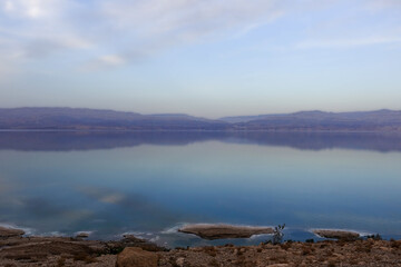 Beautiful sunset in lilac tones over the dead sea. View from Israel coast to Jordan side.