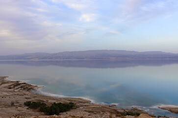Fototapeta na wymiar Beautiful sunset in lilac tones over the dead sea. View from Israel coast to Jordan side.