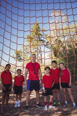 Trainer and kids standing together in the boot camp