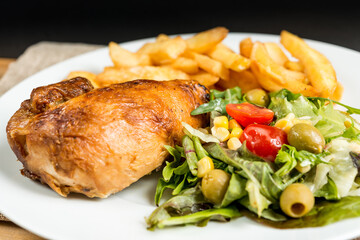 fried chicken and golden French fries potatoes