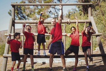 Trainer and kids standing together in the boot camp