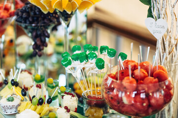 Sticks with chocolates stand in a glass vase