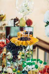 Tall cocktail glasses with grape and orange