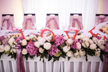 Red letters 'Love' put in a garland on the table