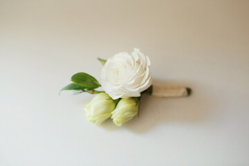 White boutonniere made of white rose