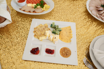 White plate with cranberry sauce and sliced cheese