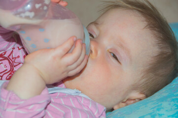 baby eats a bottle and falls asleep.