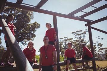 Trainer and kids relaxing in the boot camp