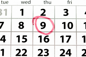 White calendar page with date circled in red