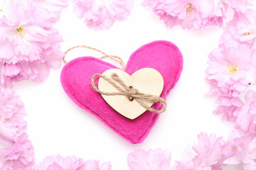 Fototapeta na wymiar Heart made of felt in pink colour and wooden heart