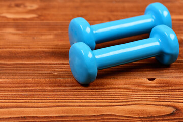 workout concept, blue dumbbells on brown vintage wooden