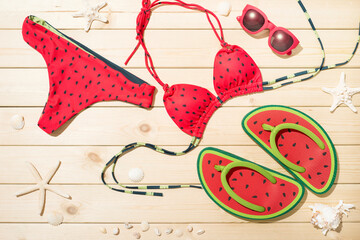 sweet cute watermelon pattern bikini and flip-flops on the wooden board