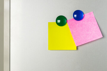 blank Sticky  note and magnet on refrigerator , two paper sheet background.