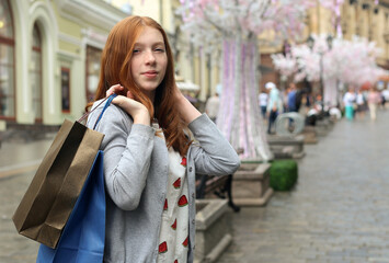 Attractive cute girl in with the shopping bags in her hands