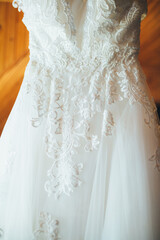 Fototapeta na wymiar The wedding dress hands on the hanger in the room