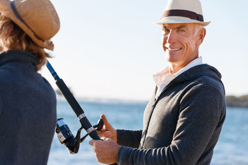 Obraz premium Senior man fishing with his grandson