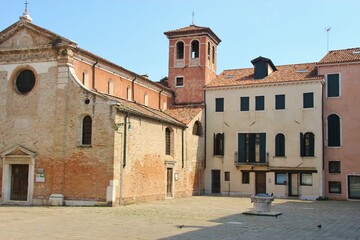 Quiet square with church and well in the district San Polo in Venice, Italy, Europe.