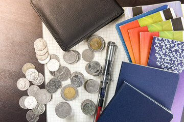 Thai money and bank saving account book on wooden table
