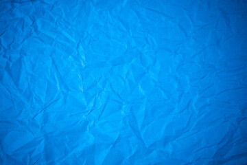 Blue paper crumpled recycle background.