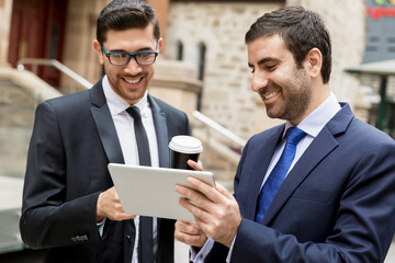 Two businessmen talking outdoors