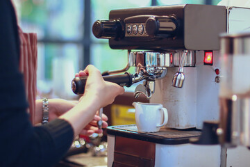 Women Barista smiling and using coffee machine in coffee shop counter - Working woman small business owner food and drink cafe concept
