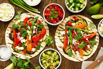 Vegetarian snack tacos with grilled vegetables and salsa.