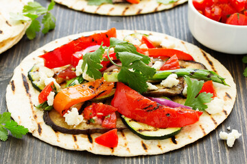 Vegetarian snack tacos with grilled vegetables and salsa.