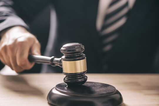 Gavel in the hand of a man in a business suit