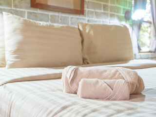 Brownish color towel on bed 1