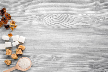 cooking sweets set with sugar in spoons on kitchen table background top view