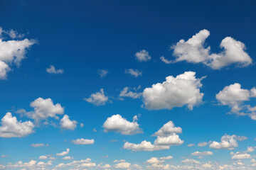 Naklejka na ściany i meble Blue sky with fluffy clouds as background