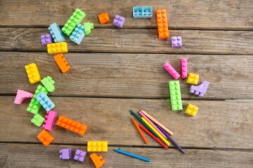 Overhead view of toy blocks with crayons