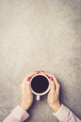 Female hands holding coffee cup
